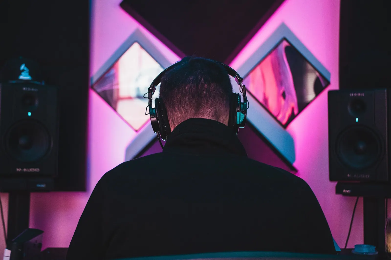 Producer wearing headphones in a studio